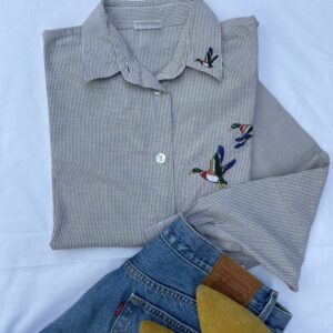 Check shirt with birds embroidered on it